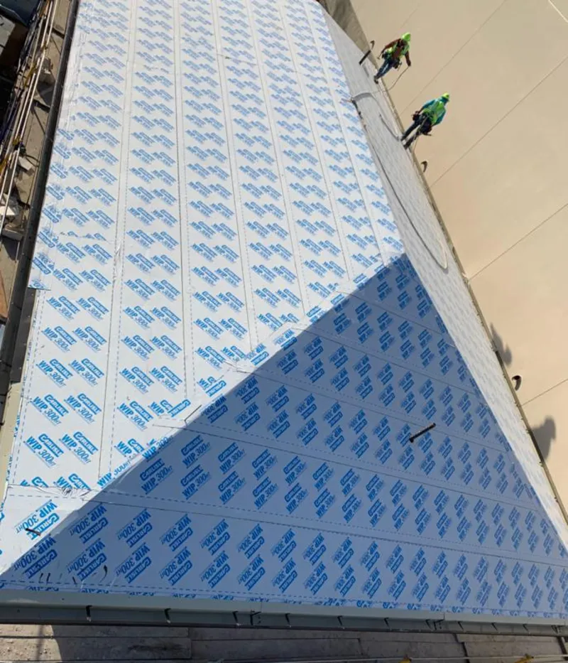 Professional roofers installing underlayment on a metal roof in Riviera Beach